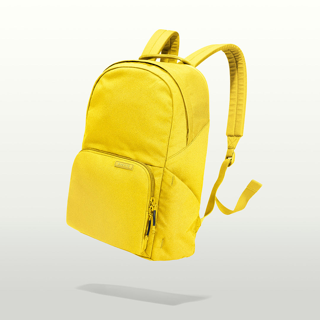 The Brevitē Backpack in Lemon Yellow, three-quarter view