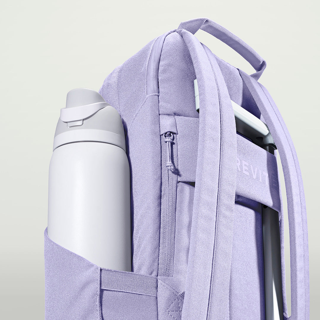 The Brevitē Backpack in Lavender Dream, large water bottle in the side pocket