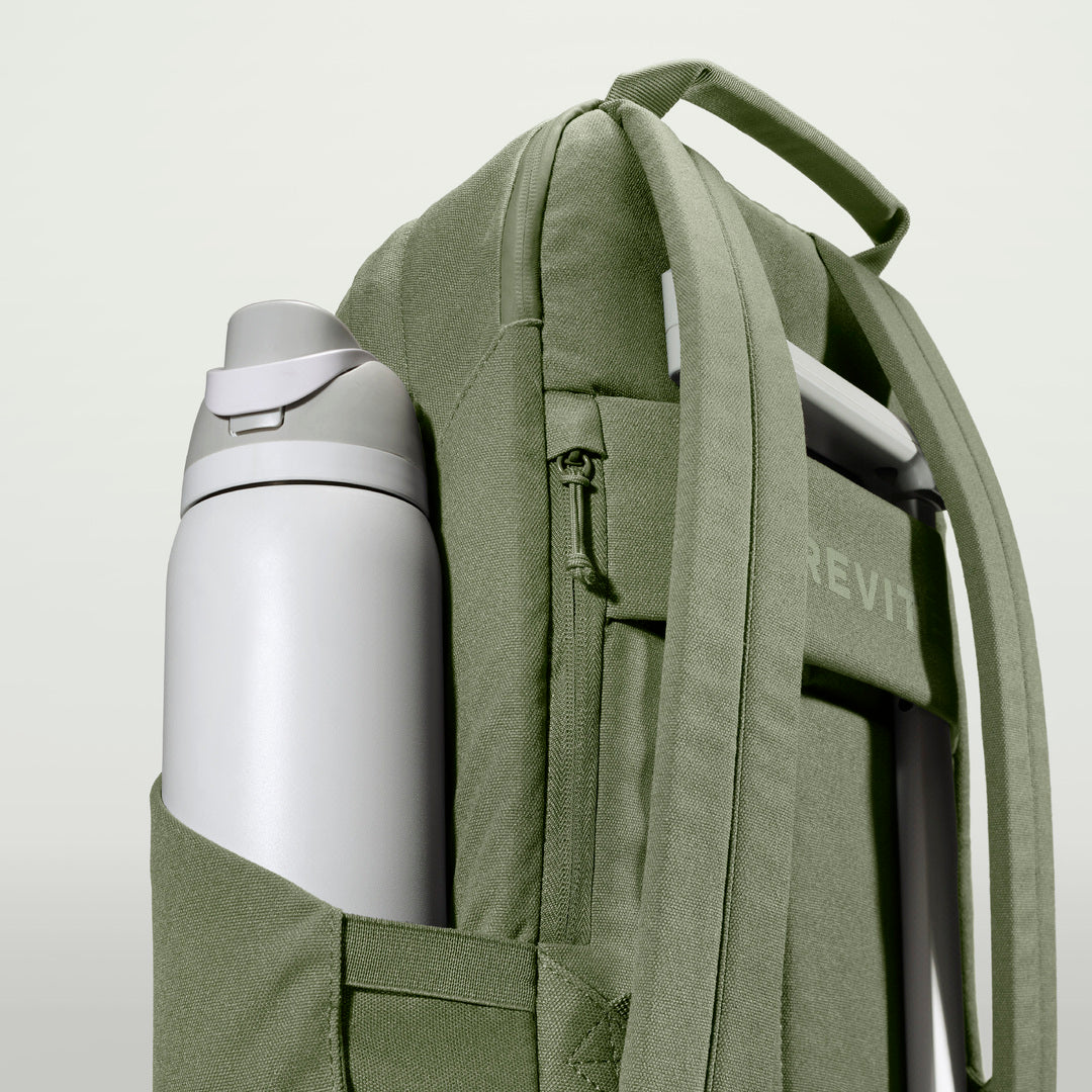 The Brevitē Backpack in Pine Green, large water bottle in the side pocket