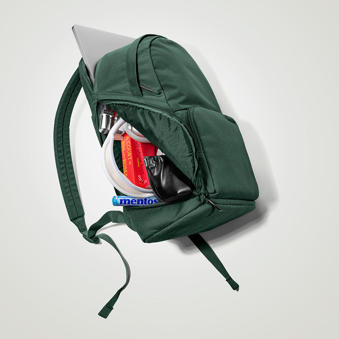 The Brevitē Backpack in Jade Green, open, showing the pockets
