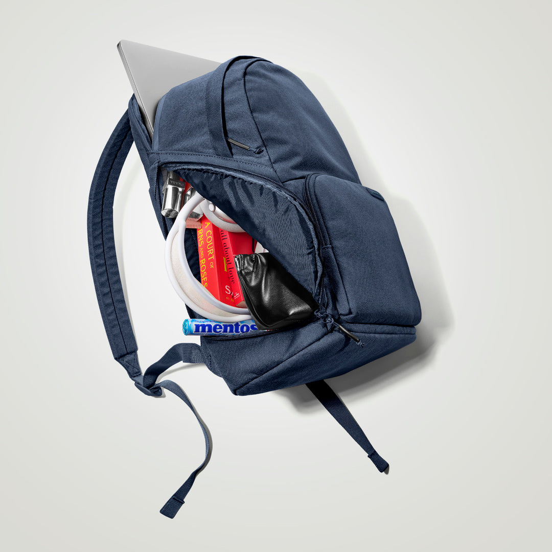 The Brevitē Backpack in Moonlit Blue, open, showing the pockets