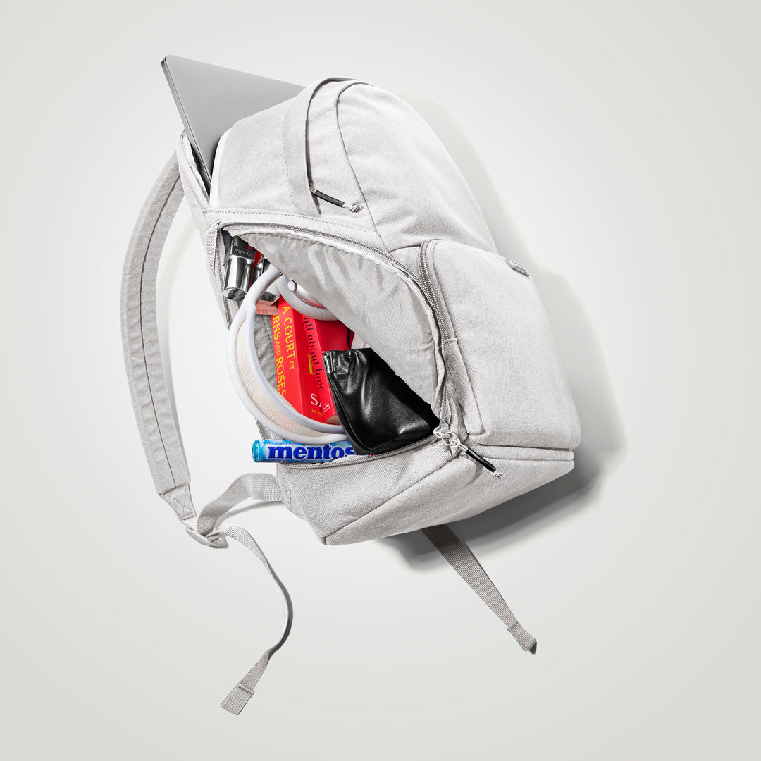 The Brevitē Backpack in Nimbus Gray, open, showing the pockets