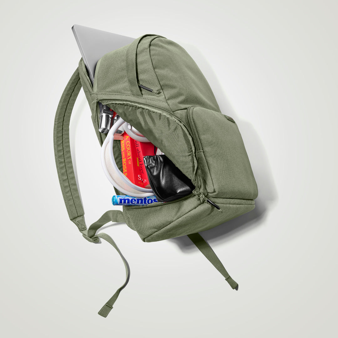 The Brevitē Backpack in Pine Green, open, showing the pockets