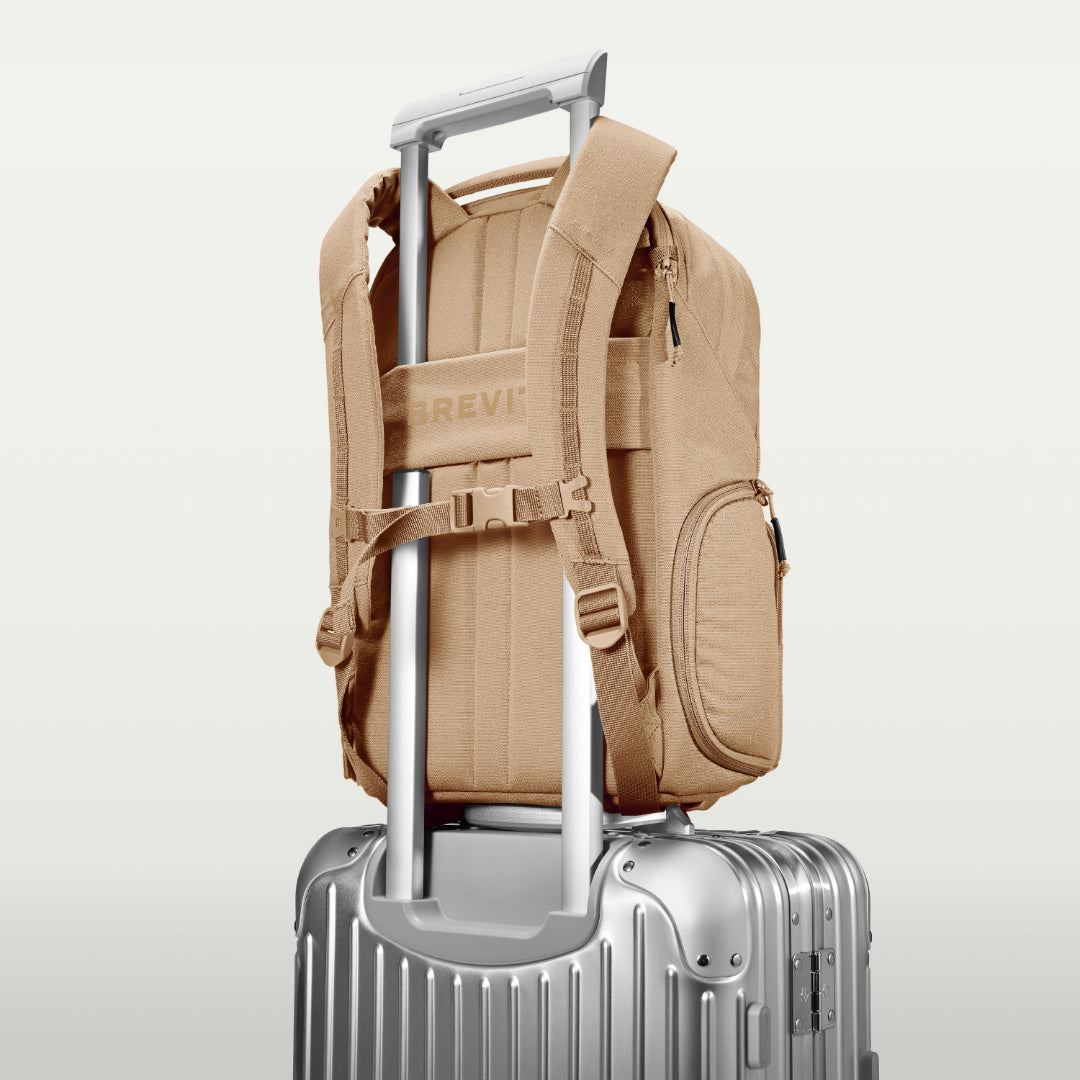The Jumper in Desert Sand, luggage strap over a suitcase handle