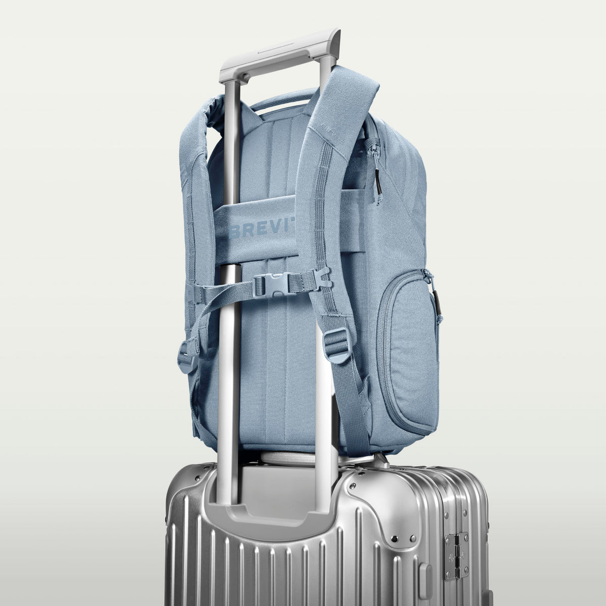 The Jumper in Niagara Mist, luggage strap over a suitcase handle