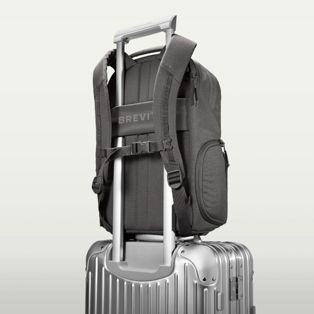 The Jumper in Poppy Seed, luggage strap over a suitcase handle