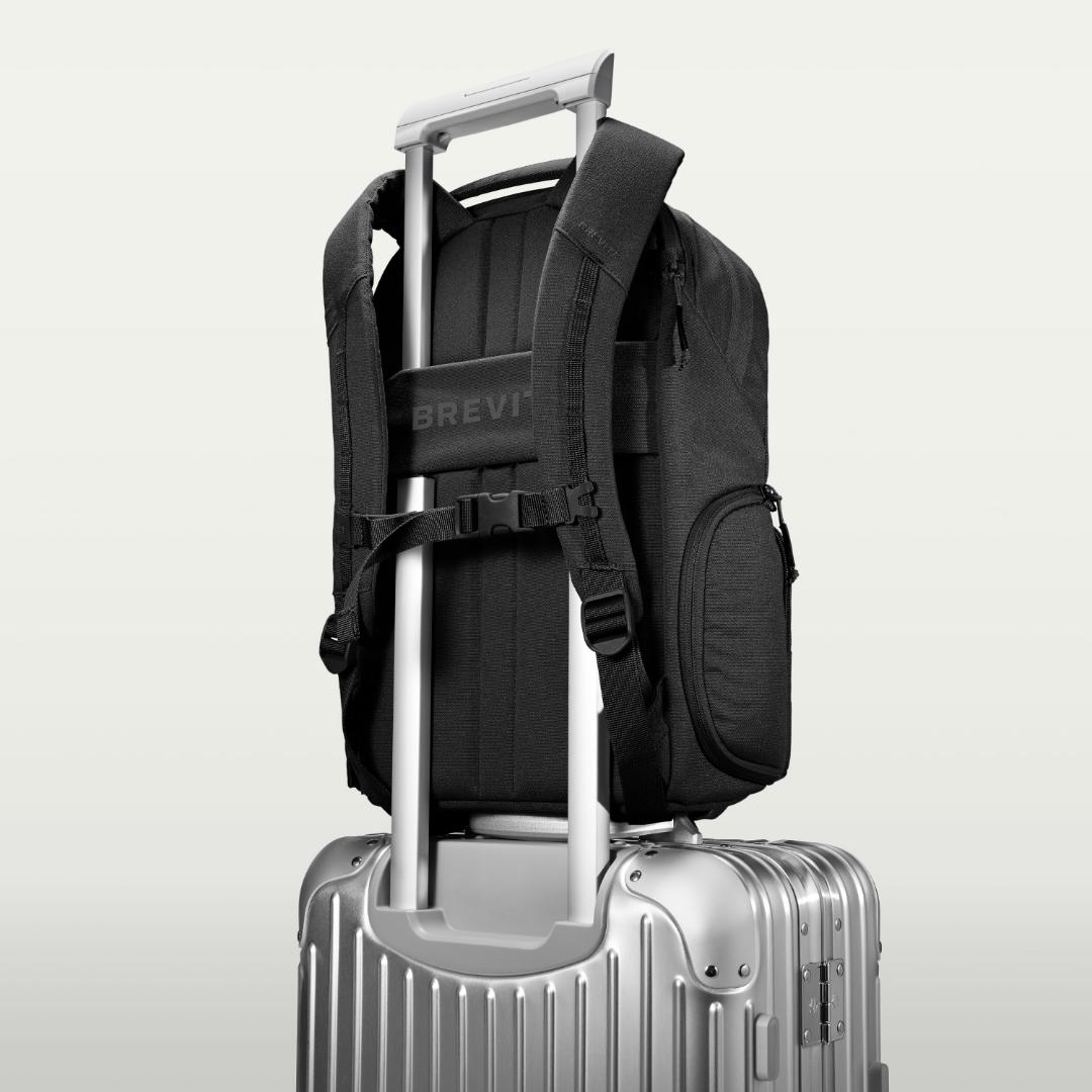 The Jumper Large in Triple Black, luggage strap over a suitcase handle