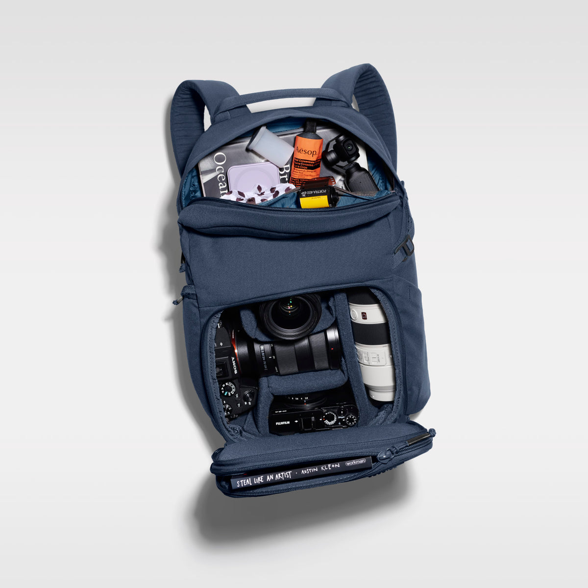 The Jumper in Moonlit Blue, open and packed with camera gear