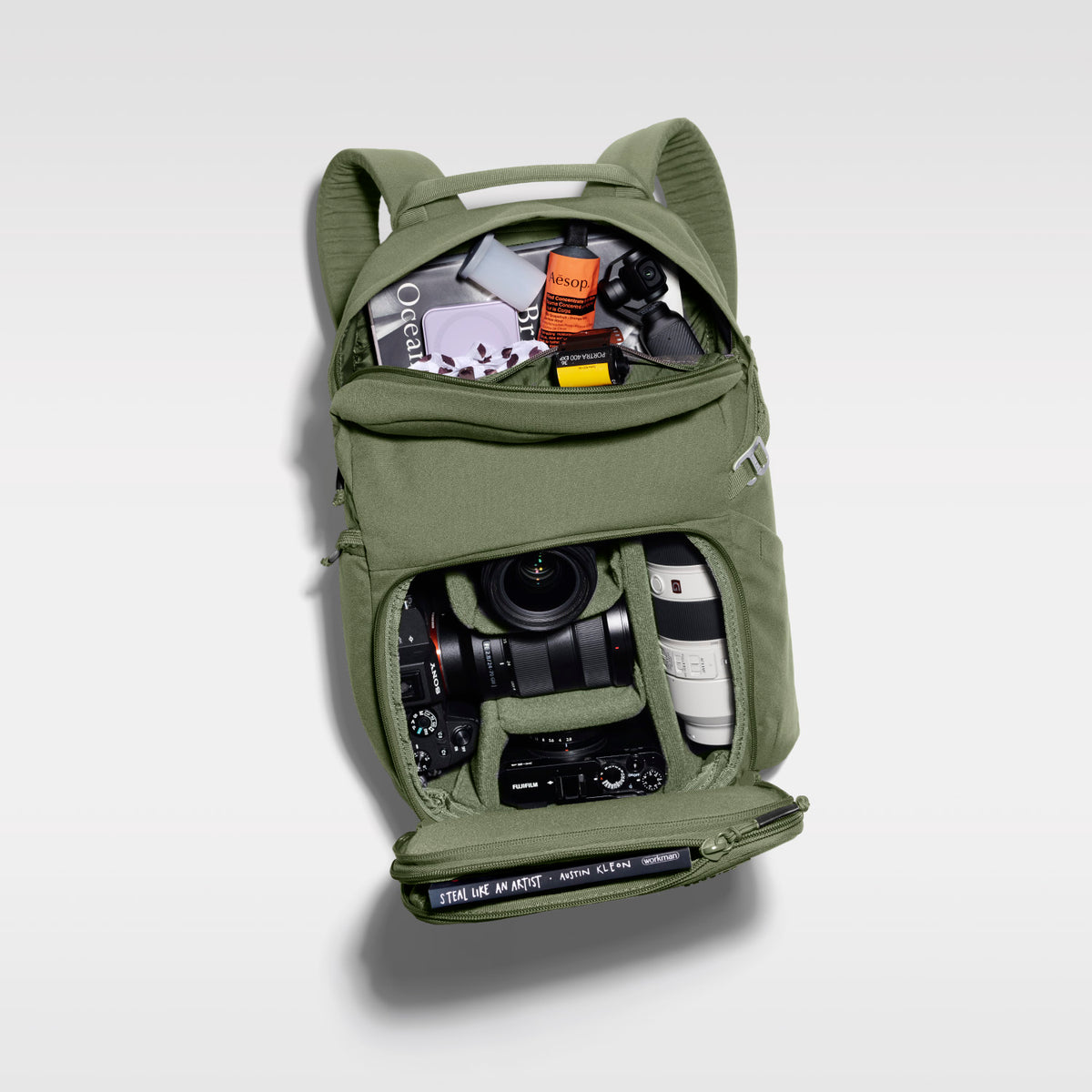 The Jumper in Pine Green, open and packed with camera gear