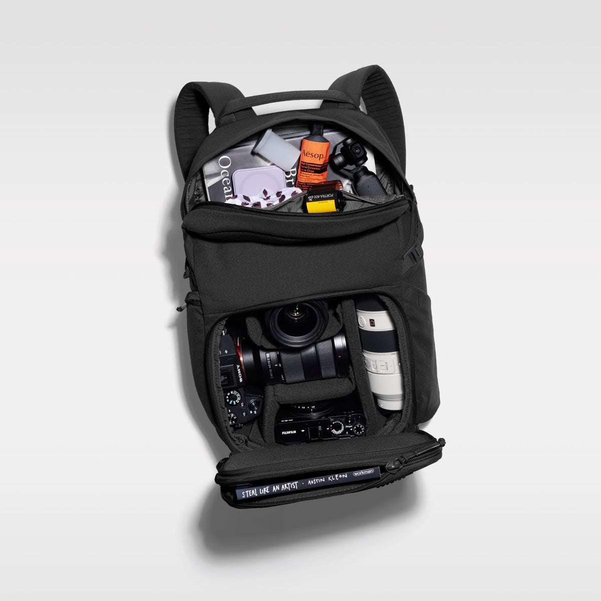 The Jumper in Triple Black, open and packed with camera gear