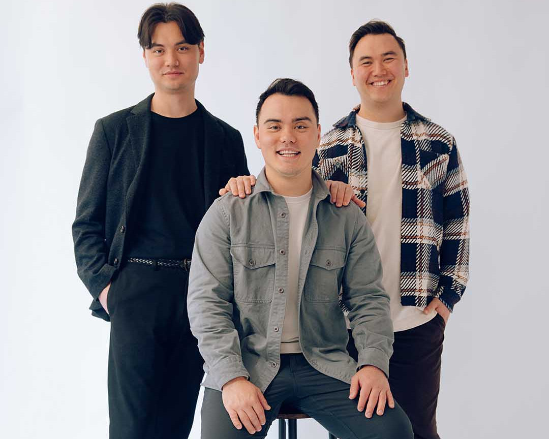 Brandon, Elliot and Dylan Kim in a group photo smiling at the camera